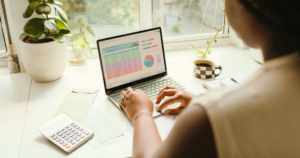 Woman at her laptop working on a household budget, representing surrogate compensation in Hawaii