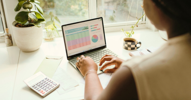Woman at her laptop working on a household budget, representing surrogate compensation in Hawaii